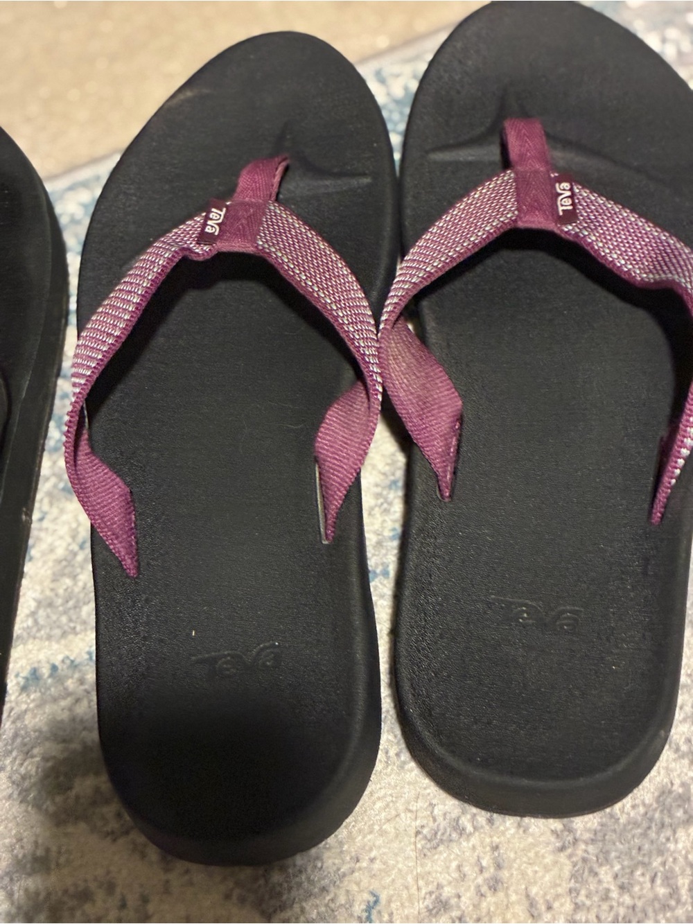 Teva Women’s Purple and Black Flip Flop Sandals and a pair of black flip flops